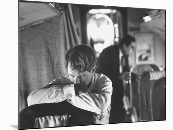 Thoughtful Senator Robert F. Kennedy on Airplane During Campaign Trip to Aid Local Candidates-Bill Eppridge-Mounted Photographic Print