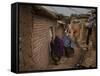 Three Afghan Refugee Women and their Children Walk in an Alley of a Poor Neighborhood in Pakistan-null-Framed Stretched Canvas