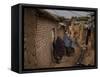 Three Afghan Refugee Women and their Children Walk in an Alley of a Poor Neighborhood in Pakistan-null-Framed Stretched Canvas