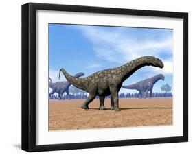 Three Argentinosaurus Dinosaurs Walking in the Desert-null-Framed Art Print