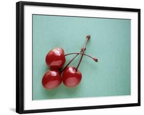 Three Cherries on a Green Background-Karen M^ Romanko-Framed Photographic Print