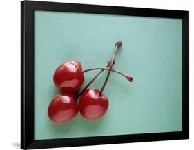 Three Cherries on a Green Background-Karen M^ Romanko-Framed Photographic Print