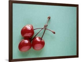 Three Cherries on a Green Background-Karen M^ Romanko-Framed Photographic Print