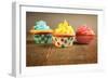 Three Different Colors Cupcakes On A Wooden Table, Blue, Yellow And Pink-pink candy-Framed Art Print