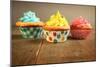 Three Different Colors Cupcakes On A Wooden Table, Blue, Yellow And Pink-pink candy-Mounted Art Print