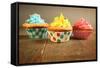 Three Different Colors Cupcakes On A Wooden Table, Blue, Yellow And Pink-pink candy-Framed Stretched Canvas
