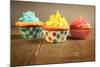 Three Different Colors Cupcakes On A Wooden Table, Blue, Yellow And Pink-pink candy-Mounted Art Print