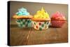 Three Different Colors Cupcakes On A Wooden Table, Blue, Yellow And Pink-pink candy-Stretched Canvas