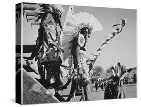 Three Indians In Headdress Watching Tourists "Dance San Ildefonso Pueblo New Mexico 1942." 1942-Ansel Adams-Stretched Canvas