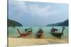 Three long tailed boats on a sandy beach, Thailand-Sergio Pitamitz-Stretched Canvas