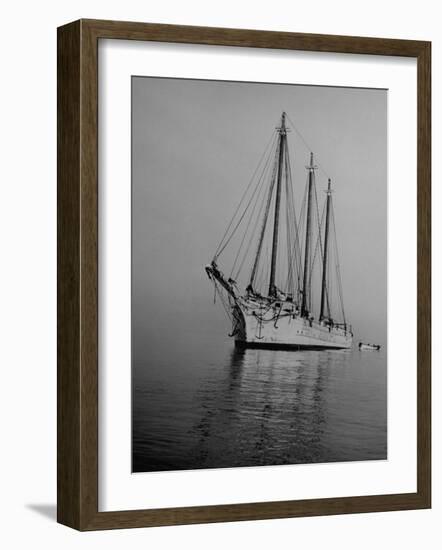 Three-Masted Schooner, Sails Furled, on the Water with a Dinghy in Tow-Bernard Hoffman-Framed Photographic Print