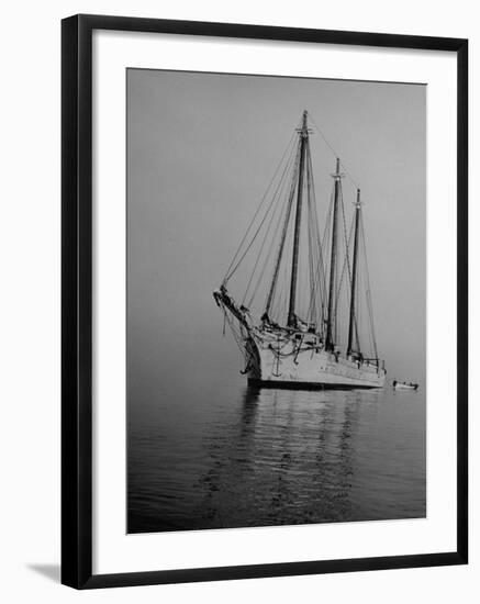 Three-Masted Schooner, Sails Furled, on the Water with a Dinghy in Tow-Bernard Hoffman-Framed Photographic Print