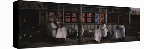 Three Men Getting a Hair Cut in Front of a Building, Beijing, China-null-Stretched Canvas