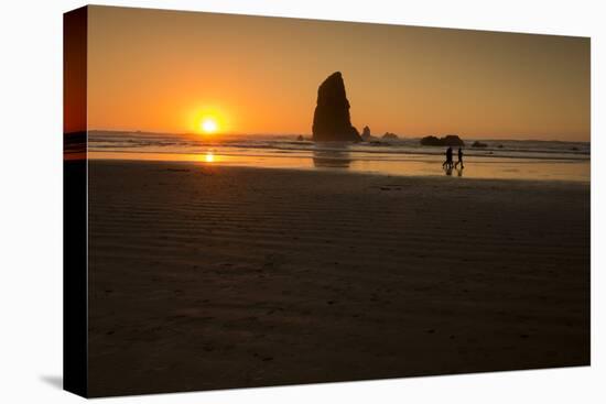 Three People Walk Along Cannon Beach, Oregon, at Sunset-Ben Coffman-Stretched Canvas