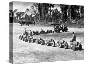 Three U.S. Marines Ride on a Truck Drawn Bomb Train at a Pacific Air Base, 1944-null-Stretched Canvas