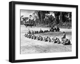 Three U.S. Marines Ride on a Truck Drawn Bomb Train at a Pacific Air Base, 1944-null-Framed Photo