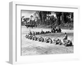 Three U.S. Marines Ride on a Truck Drawn Bomb Train at a Pacific Air Base, 1944-null-Framed Photo