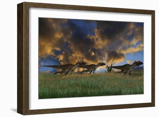 Three Utahraptors Running across Prehistoric Grasslands-null-Framed Art Print