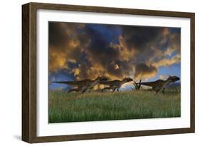 Three Utahraptors Running across Prehistoric Grasslands-null-Framed Art Print