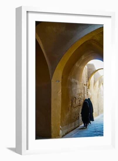 Three women in chadors hurrying down typical vaulted alleyway, Yazd, Iran, Middle East-James Strachan-Framed Photographic Print