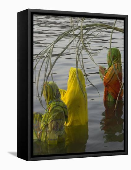 Three Women Pilgrims in Saris Making Puja Celebration in the Pichola Lake at Sunset, Udaipur, India-Eitan Simanor-Framed Stretched Canvas