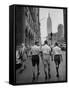 Three Young Businessmen Wearing Bermuda Shorts as They Walk Along Fifth Ave. During Lunchtime-Lisa Larsen-Framed Stretched Canvas