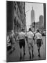 Three Young Businessmen Wearing Bermuda Shorts as They Walk Along Fifth Ave. During Lunchtime-Lisa Larsen-Mounted Premium Photographic Print