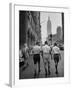 Three Young Businessmen Wearing Bermuda Shorts as They Walk Along Fifth Ave. During Lunchtime-Lisa Larsen-Framed Photographic Print
