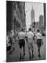 Three Young Businessmen Wearing Bermuda Shorts as They Walk Along Fifth Ave. During Lunchtime-Lisa Larsen-Mounted Photographic Print