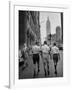 Three Young Businessmen Wearing Bermuda Shorts as They Walk Along Fifth Ave. During Lunchtime-Lisa Larsen-Framed Photographic Print