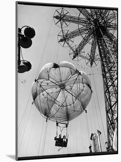 Thrillseeking Couple Take a Ride on the 300-Ft. Parachute Jump at Coney Island Amusement Park-null-Mounted Photographic Print