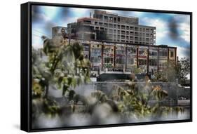 Through a fence looking at adandoned warehouse with graffiti at 5 Pointz-null-Framed Stretched Canvas