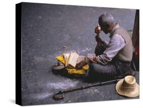 Tibetan Buddhist Pilgrim Reading Texts and Holding Prayer Wheel, Lhasa, China-Alison Wright-Stretched Canvas