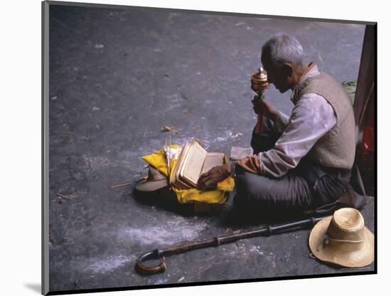 Tibetan Buddhist Pilgrim Reading Texts and Holding Prayer Wheel, Lhasa, China-Alison Wright-Mounted Photographic Print