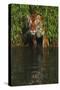 Tiger Casting Reflection in Pond Water as it Stalks from Bamboo Thicket (Captive)-Lynn M^ Stone-Stretched Canvas