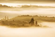 A hot air balloon flies over a trees and a temple at sunrise on a misty morning, Bagan, Myanmar-Tim Mannakee-Photographic Print