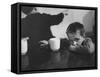 Tired Child is Ready to Go to Sleep with His Head on the Dining Room Table at Ellis Island-Alfred Eisenstaedt-Framed Stretched Canvas