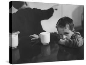 Tired Child is Ready to Go to Sleep with His Head on the Dining Room Table at Ellis Island-Alfred Eisenstaedt-Stretched Canvas