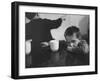 Tired Child is Ready to Go to Sleep with His Head on the Dining Room Table at Ellis Island-Alfred Eisenstaedt-Framed Photographic Print