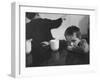 Tired Child is Ready to Go to Sleep with His Head on the Dining Room Table at Ellis Island-Alfred Eisenstaedt-Framed Photographic Print