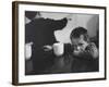 Tired Child is Ready to Go to Sleep with His Head on the Dining Room Table at Ellis Island-Alfred Eisenstaedt-Framed Photographic Print