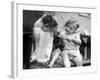 Toddler Trying to Brush Dog's Teeth-null-Framed Photographic Print