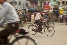 Jessore, Bangladesh. A man cycles to work through the centre of town.-Tom Martin-Photographic Print