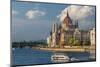 Tour boat passes Hungary's Parliament, built between 1884-1902 is the country's largest building-Tom Haseltine-Mounted Photographic Print