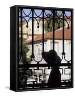 Tourist Gazes at Historic House through Iron Grillwork of Church, Lisbon, Portugal-Merrill Images-Framed Stretched Canvas