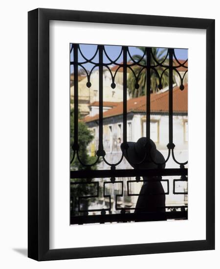 Tourist Gazes at Historic House through Iron Grillwork of Church, Lisbon, Portugal-Merrill Images-Framed Premium Photographic Print