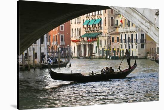 Tourist in a Gondola as They Pass under the Rialto Bridge, Venice, Italy-David Noyes-Stretched Canvas