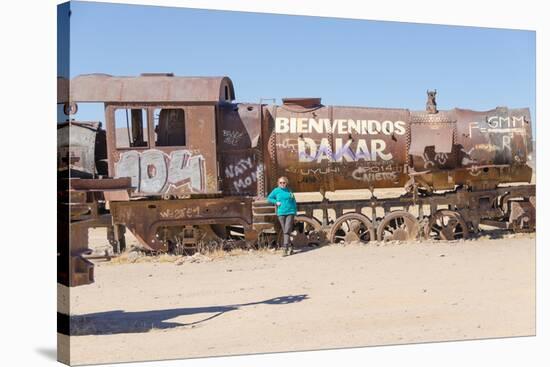 Tourist in Cementerio De Trenes (Train Cemetery), Salar De Uyuni, Bolivia-Elzbieta Sekowska-Stretched Canvas