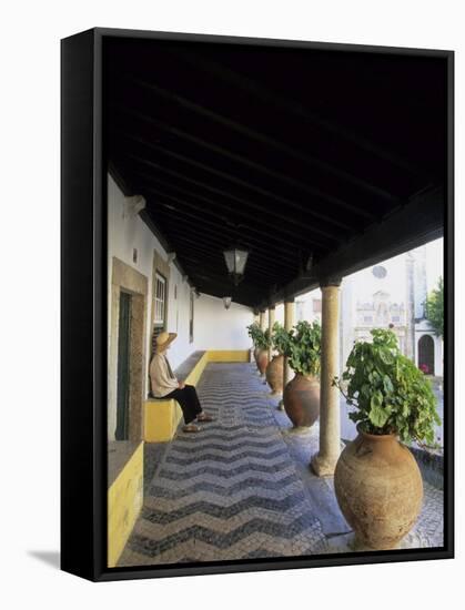 Tourist on Terrace with Striped Cobblestone Floor and Planters, Portugal-Merrill Images-Framed Stretched Canvas