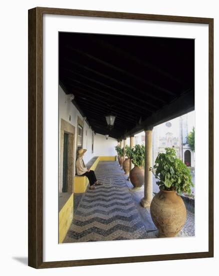 Tourist on Terrace with Striped Cobblestone Floor and Planters, Portugal-Merrill Images-Framed Photographic Print